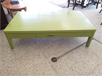 Wooden coffee table with drawer, painted green.