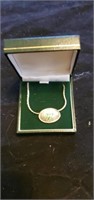 Clover necklace in box.