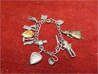 Sterling silver charm bracelet w/14 charms.