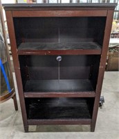 Pressed wood bookshelf. Measures 48" tall, 31"