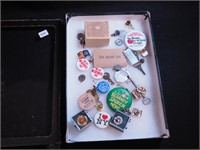 Container of pinbacks, lapel pins, carved ring