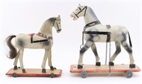Two Toy Wooden Horses on Wheels