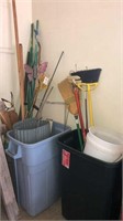 Assortment of garden stakes, brooms, trash cans