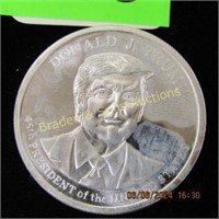 BU ONE OZ SILVER ROUND DEPICTING DONALD TRUMP.