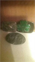 Group of three belt buckles including a Ducks