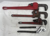 Three pipe wrenches and a pair of slip-lock