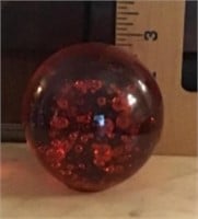 Round red glass paperweight