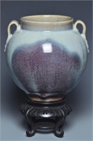 A JIN JUNYAO PURPLE SPLASHED HANDLED JAR AND STAND