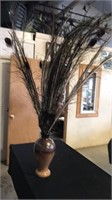 Brown vase of peacock feathers