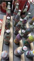 Five decorative Coca-Cola bottles