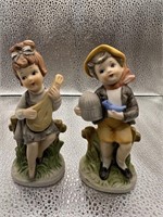 Boy and Girl sitting on fence figurines