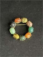 Costume brooch, stone carved scarabs