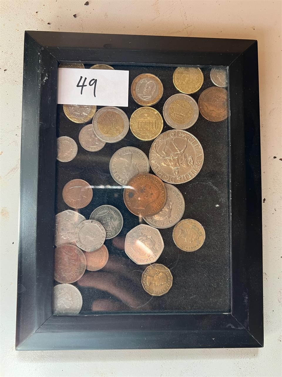 MISC FOREIGN COINS IN FRAME
