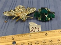 Lot with two pins: one has green stones the other