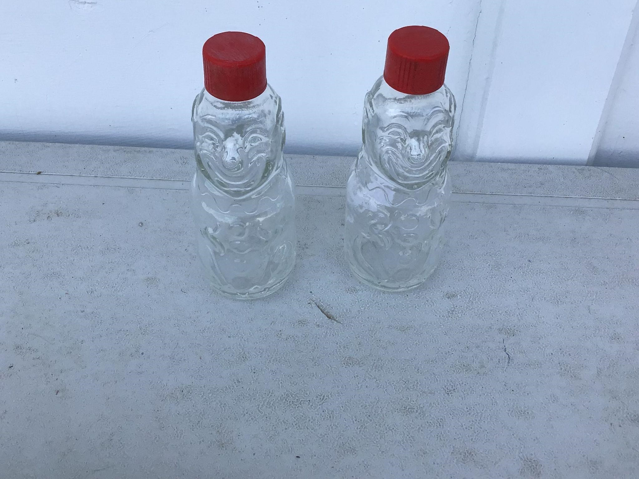 2 GLASS BOTTLES WITH FACES