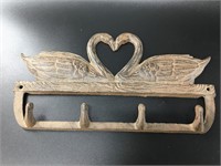 Adorable cast iron swan pair forming a heart wall