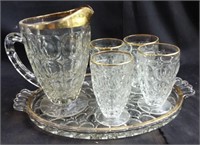 Vintage water pitcher glass on serving tray