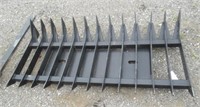 70" Root rack skid steer attachment. Located at