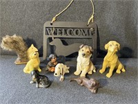 Welcome sign. Dog statues and a Squirrel