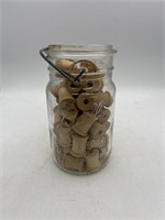 Vintage ball jar, full of wooden spools