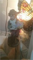 Porcelain male figure carrying flowers 8 in tall