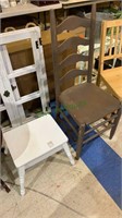 One brown ladder back chair and a small white