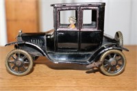 Antique tin prototype Ford Model T with driver