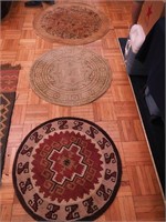 Three round throw rugs, one is wool with