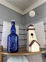 Cobalt blue bottle and lighthouse birdhouse