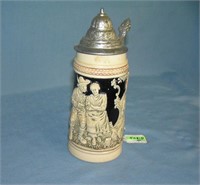 Vintage German beer stein features a couple on fro