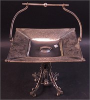 A silverplate square cake stand decorated with