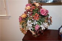 Artificial flowers with amber colored vase