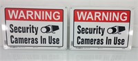 2 cameras in use tin signs