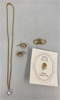 Lot includes necklace, earrings, rose pin, and an