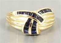 14k gold ring with channel set blue sapphires: