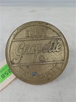 Grapette brass sidewalk marker 4"