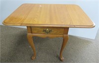 Thomasville side table with leaves and drawer.