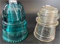 2 Glass insulators: green and clear, largest is ab