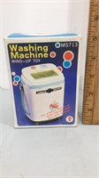 Vintage washing machine wind up toy.  Comes in