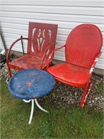 2 red metal lawn chairs with small table