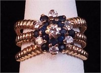 A yellow gold three-strand ring marked 14K with
