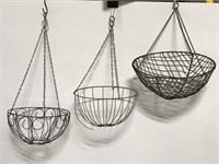 Three hanging metal plant baskets