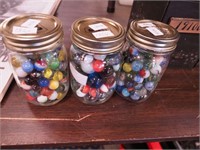 Three pint jars full of marbles