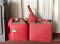 2 Red gas cans and funnel