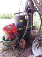 Barrel with pump and oil and gas cans