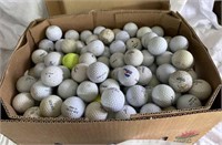 Box of golf balls includes TC Tour, Titleist,