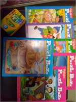 lot of activity books and colored pencils