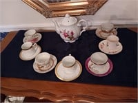 Teapot and 7 tea cups and saucers.