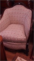 Vintage upholstered parlor armchair with wooden