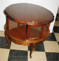 Vintage round wood side table with ornate design